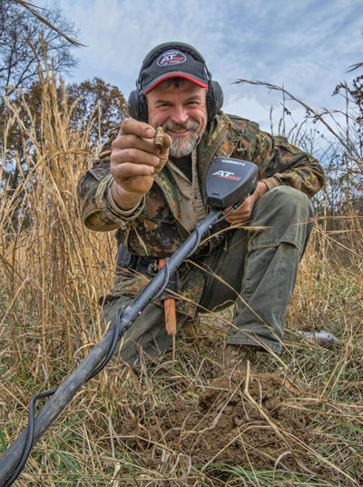 Beau Ouimette showing relic recovery in a field.