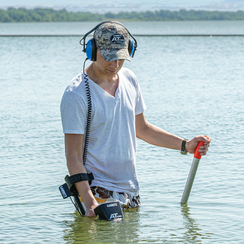 Standing in a lake using a AT Pro metal detecting under the water.